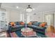 Bright living room featuring two couches, hardwood floors, and an elegant chandelier at 603 Dunbar Dr, Dunwoody, GA 30338