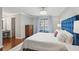 Relaxing primary bedroom with a comfortable bed, hardwood floors and stylish decor at 603 Dunbar Dr, Dunwoody, GA 30338