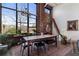 Bright dining room with exposed brick wall, large windows and unique chandelier at 174 Chester Se Ave # 127, Atlanta, GA 30316