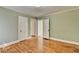 Light-filled bedroom with hardwood floors and view of multiple doorways at 2953 Hardman Ne Ct, Atlanta, GA 30305