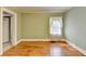 Bedroom with hardwood floors, light green walls, and large windows with sheer curtains at 2953 Hardman Ne Ct, Atlanta, GA 30305