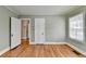 Bedroom features hardwood floors, white trim, light green walls and two doorways at 2953 Hardman Ne Ct, Atlanta, GA 30305