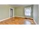 Bedroom with hardwood floors, light green walls, and large windows with sheer curtains at 2953 Hardman Ne Ct, Atlanta, GA 30305