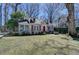 Charming home with dormer windows, red shutters, and a well-kept lawn, framed by mature trees at 2953 Hardman Ne Ct, Atlanta, GA 30305