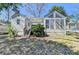 Rear view of the house featuring a sunroom with large windows and a small set of stairs to the yard at 2953 Hardman Ne Ct, Atlanta, GA 30305