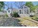 Rear view of the house featuring a sunroom with large windows and a small set of stairs to the yard at 2953 Hardman Ne Ct, Atlanta, GA 30305