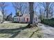 Charming home with light yellow siding, red shutters, dormer windows, and a large tree in the yard at 2953 Hardman Ne Ct, Atlanta, GA 30305