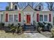 Close-up of a quaint home with red shutters, dormer windows, and a walkway leading to the inviting front entrance at 2953 Hardman Ne Ct, Atlanta, GA 30305