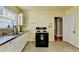 Cozy kitchen features stainless steel counters, white cabinets, and a vintage stove at 2953 Hardman Ne Ct, Atlanta, GA 30305