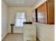 Bright laundry room with wood cabinets, window, and vintage washing machine at 2953 Hardman Ne Ct, Atlanta, GA 30305