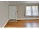 Bright living room features hardwood floors, a window, and a neutral color palette at 2953 Hardman Ne Ct, Atlanta, GA 30305