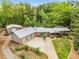 An aerial view of a brick house with a metal roof, large yard, and three car garage at 3568 Univeter Rd, Canton, GA 30115