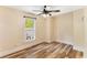 Bright bedroom with a ceiling fan and hardwood floors, providing a cozy space at 3568 Univeter Rd, Canton, GA 30115