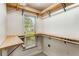 Walk-in closet with built-in wooden shelving and natural light from a window at 3568 Univeter Rd, Canton, GA 30115