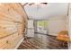 Bright laundry room features wood walls, wood floors, stacked washer/dryer and ceiling fan at 3568 Univeter Rd, Canton, GA 30115