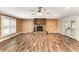 Spacious living room with wood-paneled walls, a fireplace, and lots of natural light at 3568 Univeter Rd, Canton, GA 30115