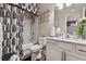 Well-lit bathroom featuring a shower with bathtub, vanity, white marbled counter, and decorative blue accents at 4727 Tiger Blvd, Duluth, GA 30096