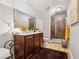 Well-lit bathroom featuring a vanity with double sinks and a glass-enclosed shower at 4727 Tiger Blvd, Duluth, GA 30096