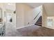 Bright hallway with carpeted floors and staircase leading to the upper level at 4727 Tiger Blvd, Duluth, GA 30096