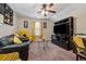 Cozy living room featuring a ceiling fan, large TV, and comfortable seating at 4727 Tiger Blvd, Duluth, GA 30096