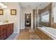 Main bathroom with dual vanity, a soaking tub, glass shower, and walk in closet at 4727 Tiger Blvd, Duluth, GA 30096