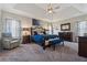 Expansive main bedroom suite with tray ceilings, a king-size bed, and a cozy seating area at 4727 Tiger Blvd, Duluth, GA 30096