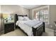 Cozy bedroom features a queen size bed with natural light streaming in from a large window at 4805 W Village Se Way # 2108, Smyrna, GA 30080