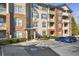 Apartment building exterior view showing accessible parking spaces, landscaped bushes, and column-supported entryway at 4805 W Village Se Way # 2108, Smyrna, GA 30080