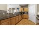 Well-lit kitchen with wooden cabinets, stainless steel appliances, and dark countertops at 4805 W Village Se Way # 2108, Smyrna, GA 30080