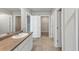 Bathroom featuring double sinks, cabinet space, and doorway to walk-in closet at 1540 Denver Way, Locust Grove, GA 30248