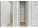 Bathroom featuring a walk-in shower, storage shelves, and a neutral color palette at 1540 Denver Way, Locust Grove, GA 30248
