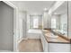 Bathroom featuring a shower, soaking tub, and double sinks with lots of light at 1540 Denver Way, Locust Grove, GA 30248