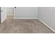 Bedroom with neutral carpeting and a walk-in closet offers comfort and storage at 1540 Denver Way, Locust Grove, GA 30248