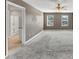 Spacious bedroom featuring plush carpet, a ceiling fan, and natural light at 1540 Denver Way, Locust Grove, GA 30248
