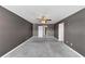 Spacious bedroom with neutral carpet and multiple doors and ample space at 1540 Denver Way, Locust Grove, GA 30248