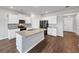 The modern kitchen has stainless appliances, granite countertops, a large island, and easy access to living areas at 1540 Denver Way, Locust Grove, GA 30248