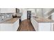 Well-equipped kitchen with stainless steel appliances, granite countertops, and white cabinetry, perfect for cooking at 1540 Denver Way, Locust Grove, GA 30248