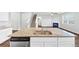 Eat-in kitchen with granite island features a built-in dishwasher and overlooks the living area with fireplace at 1540 Denver Way, Locust Grove, GA 30248