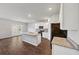 Open kitchen featuring stainless appliances, a large kitchen island and adjacent to the living and dining areas at 1540 Denver Way, Locust Grove, GA 30248