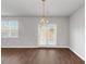 Bright living room features wood floors, large windows, and a glass panel patio door at 1540 Denver Way, Locust Grove, GA 30248