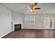 Open-concept living room with an electric fireplace and a glass panel patio door at 1540 Denver Way, Locust Grove, GA 30248
