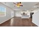 Open-concept living space with kitchen, dining area, and wood floors at 1540 Denver Way, Locust Grove, GA 30248