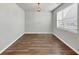 Neutral living area featuring hardwood flooring and natural light from the large window at 1540 Denver Way, Locust Grove, GA 30248