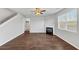 Living room features an electric fireplace, wood floors, and large windows at 1540 Denver Way, Locust Grove, GA 30248