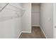 Neutral walk-in closet with metal shelving, providing ample storage space for an organized wardrobe at 1540 Denver Way, Locust Grove, GA 30248