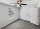 Carpeted bedroom featuring neutral walls, ceiling fan, and window with blinds at 4152 Coconut Nw Grv, Acworth, GA 30101