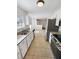 Well-lit kitchen with stainless steel appliances and white cabinets overlooking dining area at 4152 Coconut Nw Grv, Acworth, GA 30101