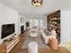 Bright living room featuring fireplace, hardwood floors, and stylish furniture, virtually staged at 4152 Coconut Nw Grv, Acworth, GA 30101