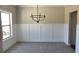 Spacious dining room featuring wainscoting and a modern chandelier at 480 Brown Dove Ln, Grayson, GA 30017