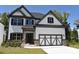 Beautiful two-story home featuring a stone-accented facade, a garage, and a well-manicured lawn at 480 Brown Dove Ln, Grayson, GA 30017